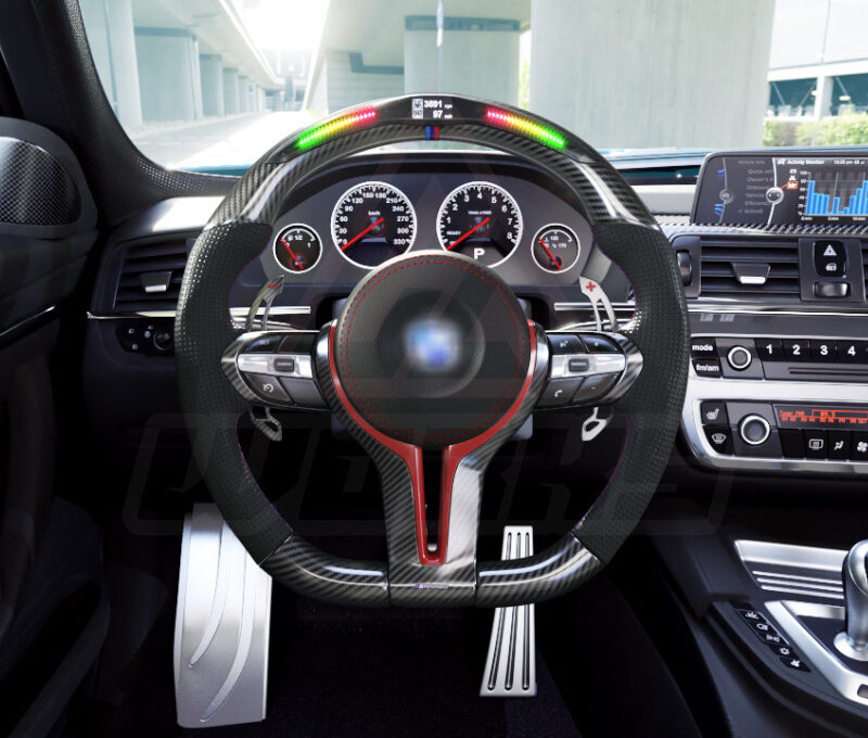 Front view of a BMW F chassis, M sport steering wheel in carbon fiber, hollow design paddle shifters, a mix of red and M color accents, black perforated leather and led shift lights